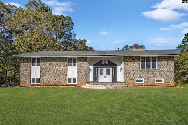 bi-level home with french doors and a front lawn