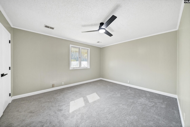 carpeted spare room featuring ornamental molding, a textured ceiling, and ceiling fan