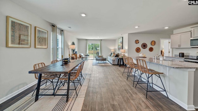 dining area featuring hardwood / wood-style flooring and sink