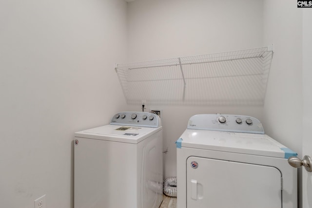 clothes washing area featuring washer and dryer