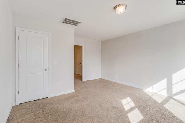 spare room with light colored carpet