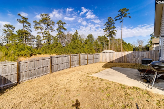 view of yard featuring central AC unit and a patio area