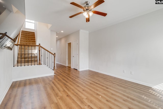 empty room with ceiling fan, ornamental molding, and light hardwood / wood-style flooring