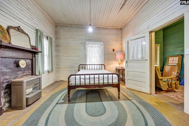 bedroom with heating unit and light hardwood / wood-style flooring