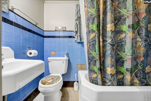 bathroom with tile patterned flooring, sink, tile walls, and toilet