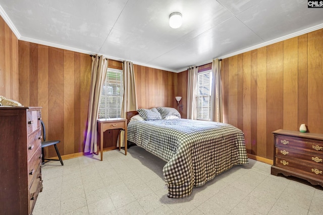 bedroom featuring crown molding, multiple windows, and wood walls