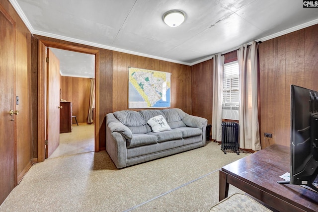 living room featuring radiator, wooden walls, and ornamental molding