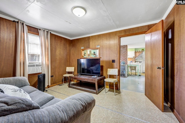 living room featuring cooling unit, crown molding, radiator heating unit, and wood walls