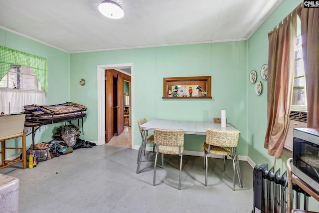 dining area with concrete flooring and crown molding