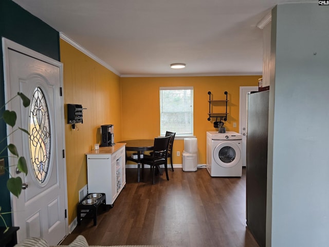 laundry area with ornamental molding and dark wood-type flooring