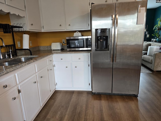 kitchen with white cabinetry, appliances with stainless steel finishes, dark hardwood / wood-style flooring, and sink