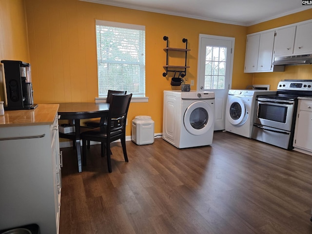 clothes washing area with crown molding, dark hardwood / wood-style floors, and washer and dryer