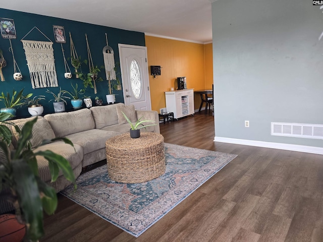 living room with ornamental molding and dark hardwood / wood-style floors