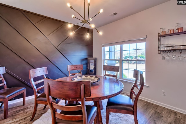 dining space with a chandelier and hardwood / wood-style floors