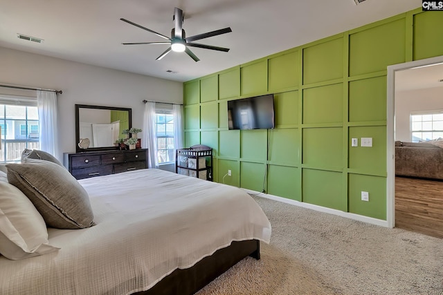 bedroom with multiple windows, carpet, and ceiling fan