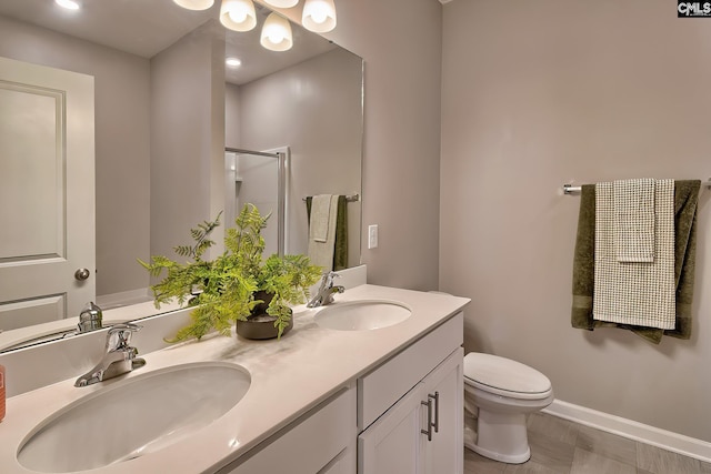 bathroom featuring vanity, an enclosed shower, and toilet