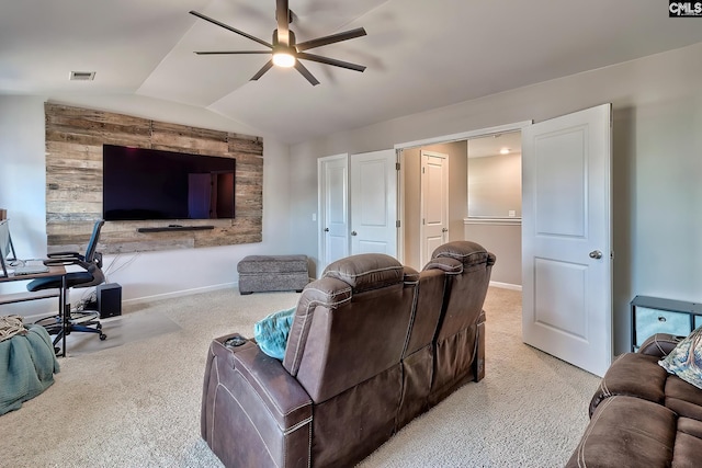 living room featuring vaulted ceiling, light colored carpet, and ceiling fan