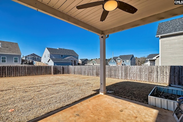 view of yard with ceiling fan and a patio