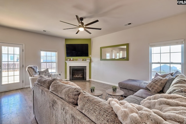 living room featuring ceiling fan and hardwood / wood-style floors