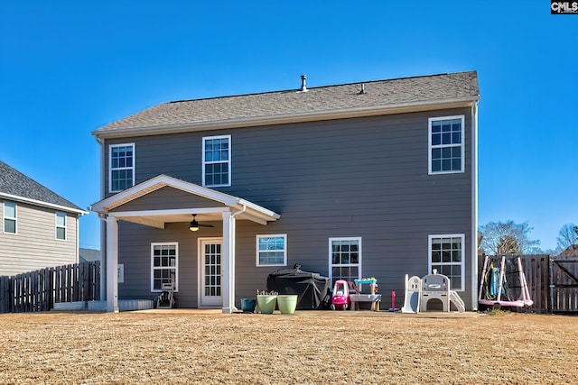 back of house featuring a yard and ceiling fan