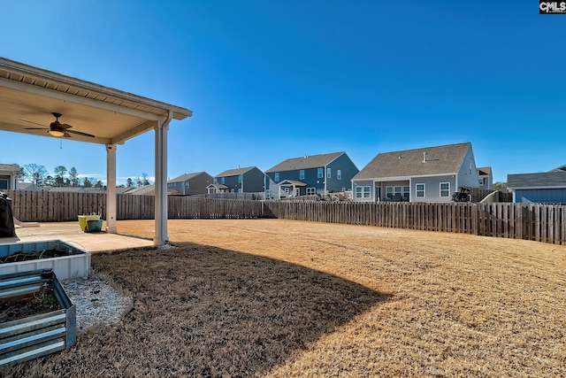 view of yard with ceiling fan and a patio area