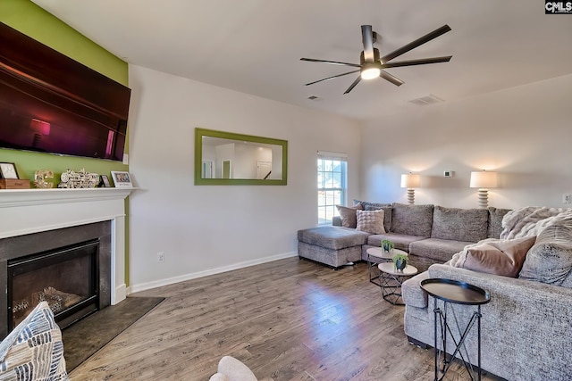 living room featuring hardwood / wood-style floors and ceiling fan