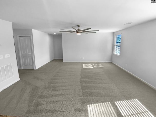 unfurnished room featuring ceiling fan and dark carpet