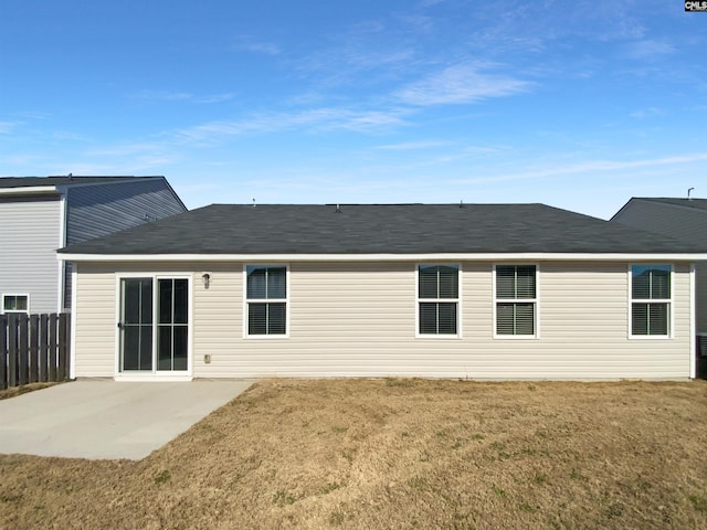 back of property with a patio area and a lawn