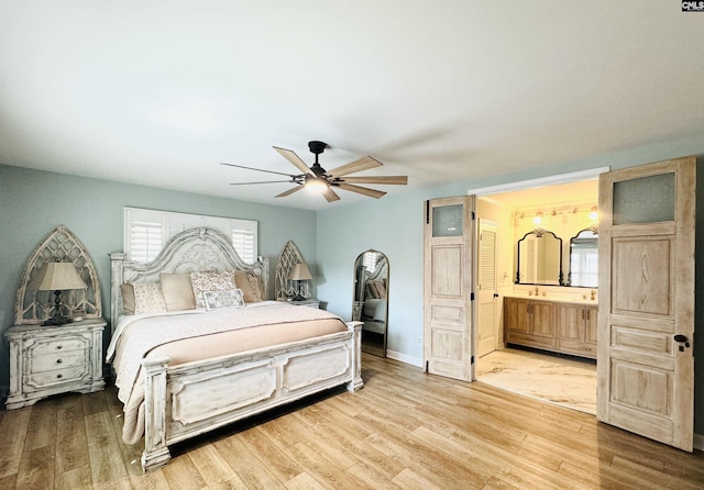 bedroom with connected bathroom, ceiling fan, baseboards, and wood finished floors