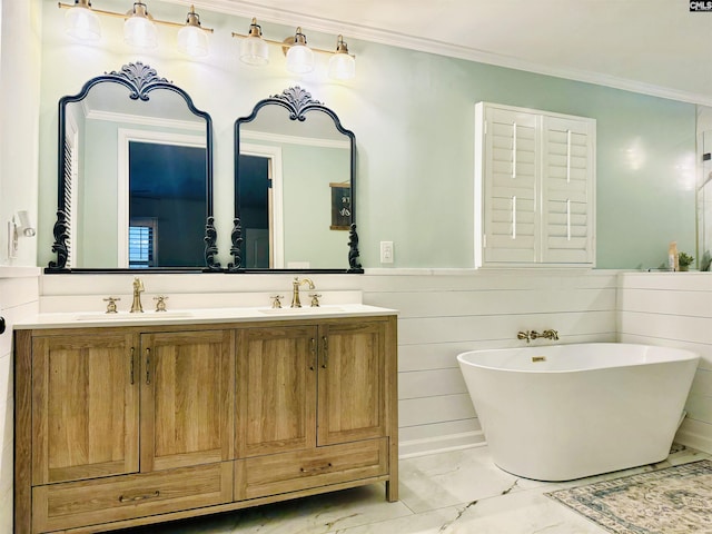 bathroom featuring wainscoting, marble finish floor, ornamental molding, and a sink