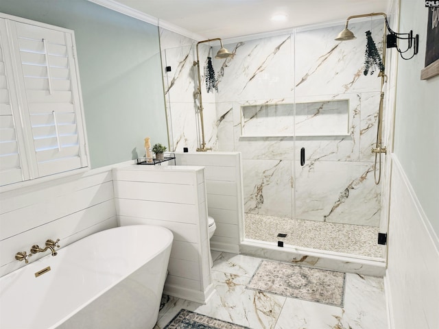 bathroom with a freestanding tub, toilet, marble finish floor, ornamental molding, and a marble finish shower