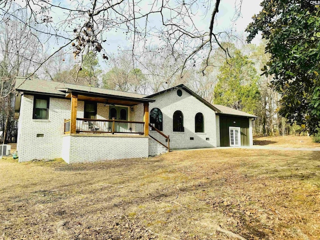 view of front of property with central AC, covered porch, and a front yard