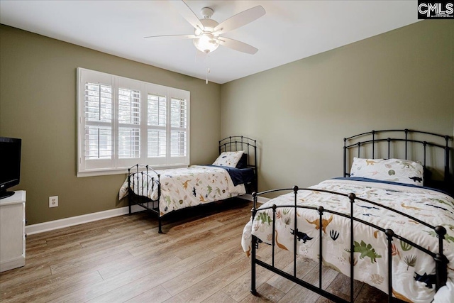 bedroom featuring light wood-type flooring, baseboards, and ceiling fan