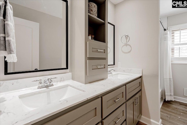 bathroom featuring hardwood / wood-style flooring, vanity, and shower / tub combo with curtain