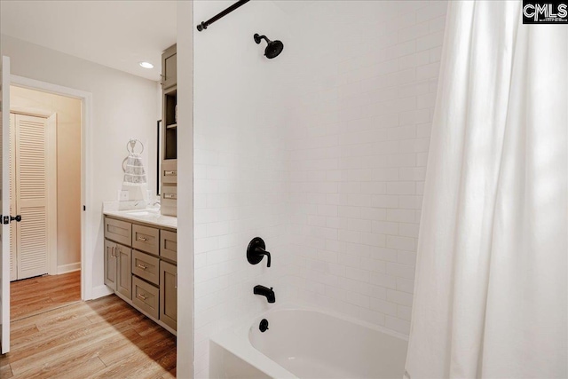 bathroom featuring shower / bath combination with curtain, vanity, and hardwood / wood-style floors