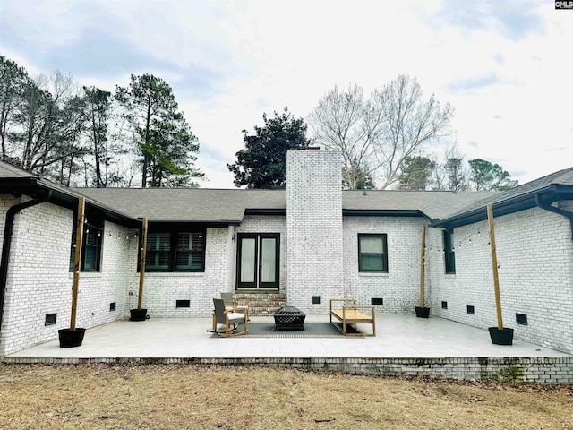 back of house featuring a patio and an outdoor fire pit