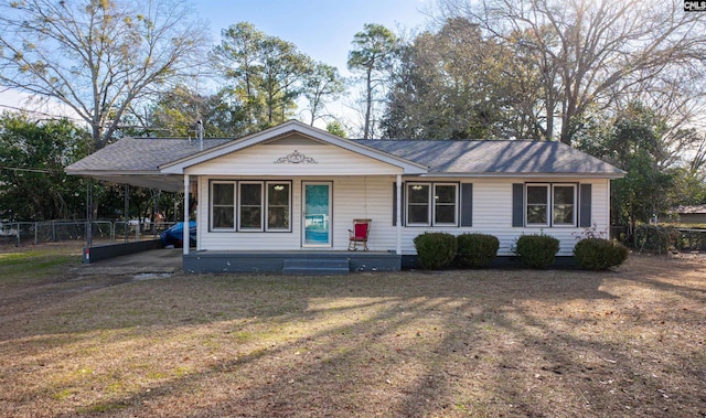 view of front of property featuring a front yard, a carport, and covered porch