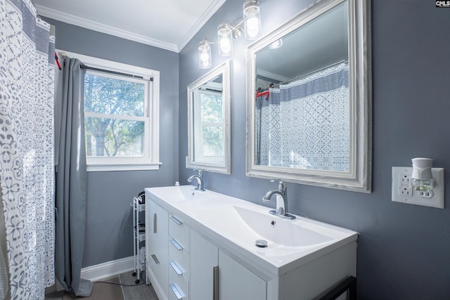 bathroom with ornamental molding and vanity