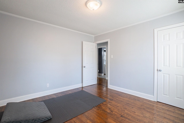 unfurnished room with ornamental molding, dark hardwood / wood-style floors, and a textured ceiling