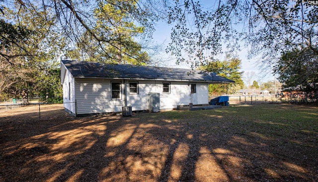 rear view of house with a yard