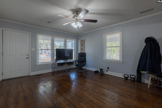 unfurnished living room featuring ceiling fan, dark wood-type flooring, ornamental molding, and a textured ceiling