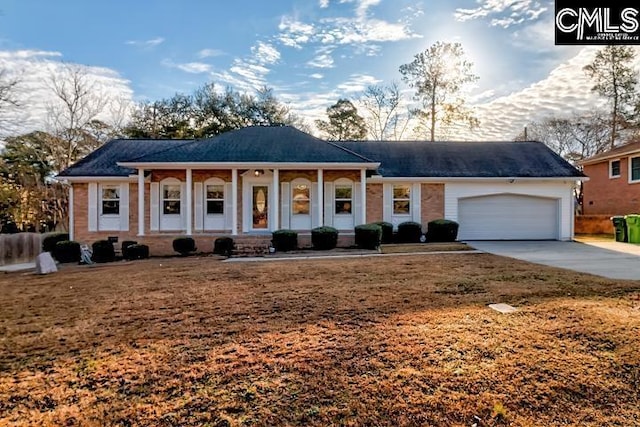 view of front facade featuring a garage, covered porch, and a front lawn