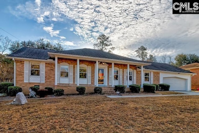 ranch-style home with a porch, a garage, and a front yard