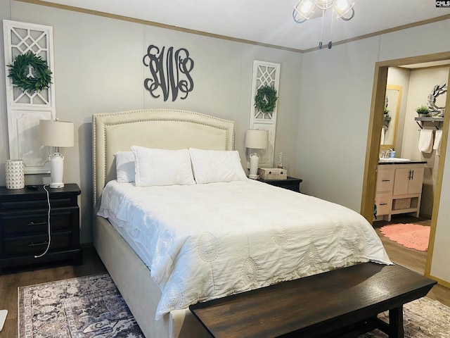 bedroom with crown molding, dark hardwood / wood-style floors, and sink