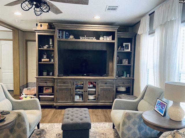 living room with hardwood / wood-style flooring and ceiling fan