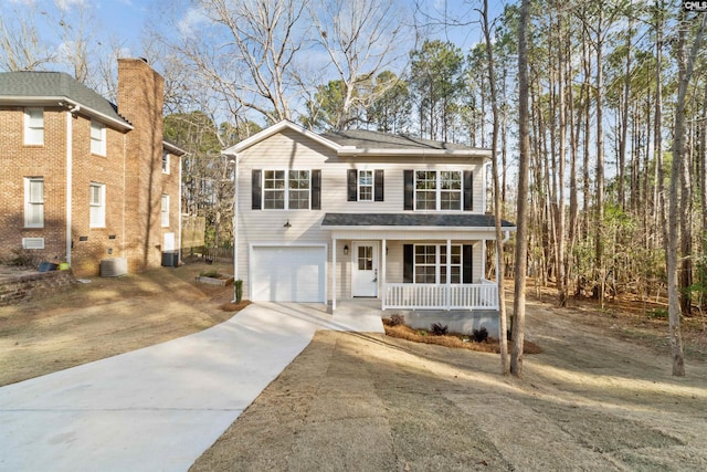 front of property featuring a porch, a garage, and cooling unit