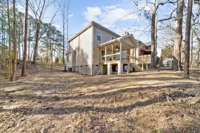 back of house with central AC and ceiling fan