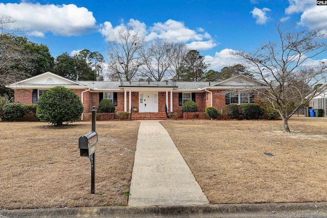 ranch-style home featuring a front yard