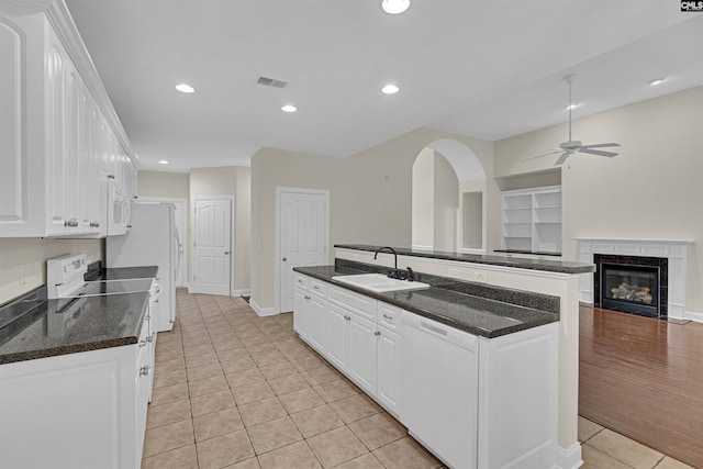 kitchen with white cabinetry, sink, and white appliances