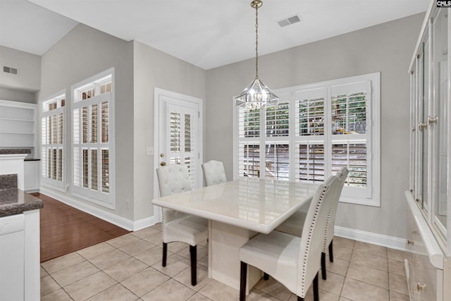 tiled dining area with an inviting chandelier